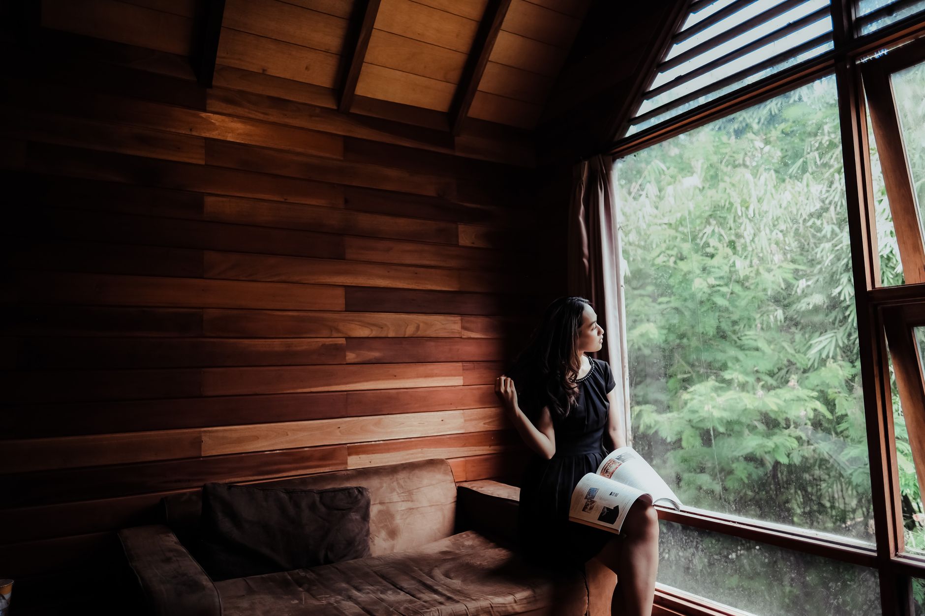 Travel essayist reading notes in minimalist cabin